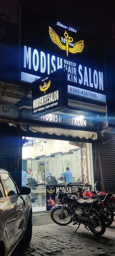 Modish Hair Salon illuminated signboard at night on PIA Main Boulevard